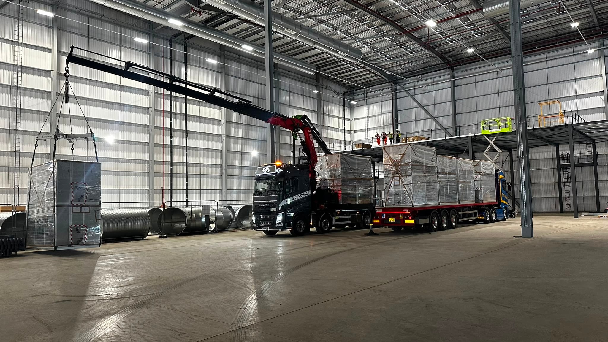 Warehouse lift of shrink-wrapped industrial units