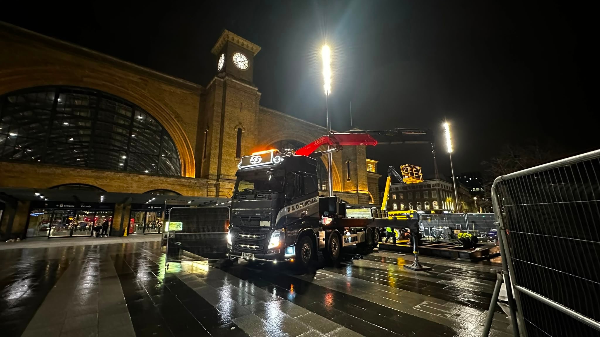 Fassi crane lifting a black industrial unit